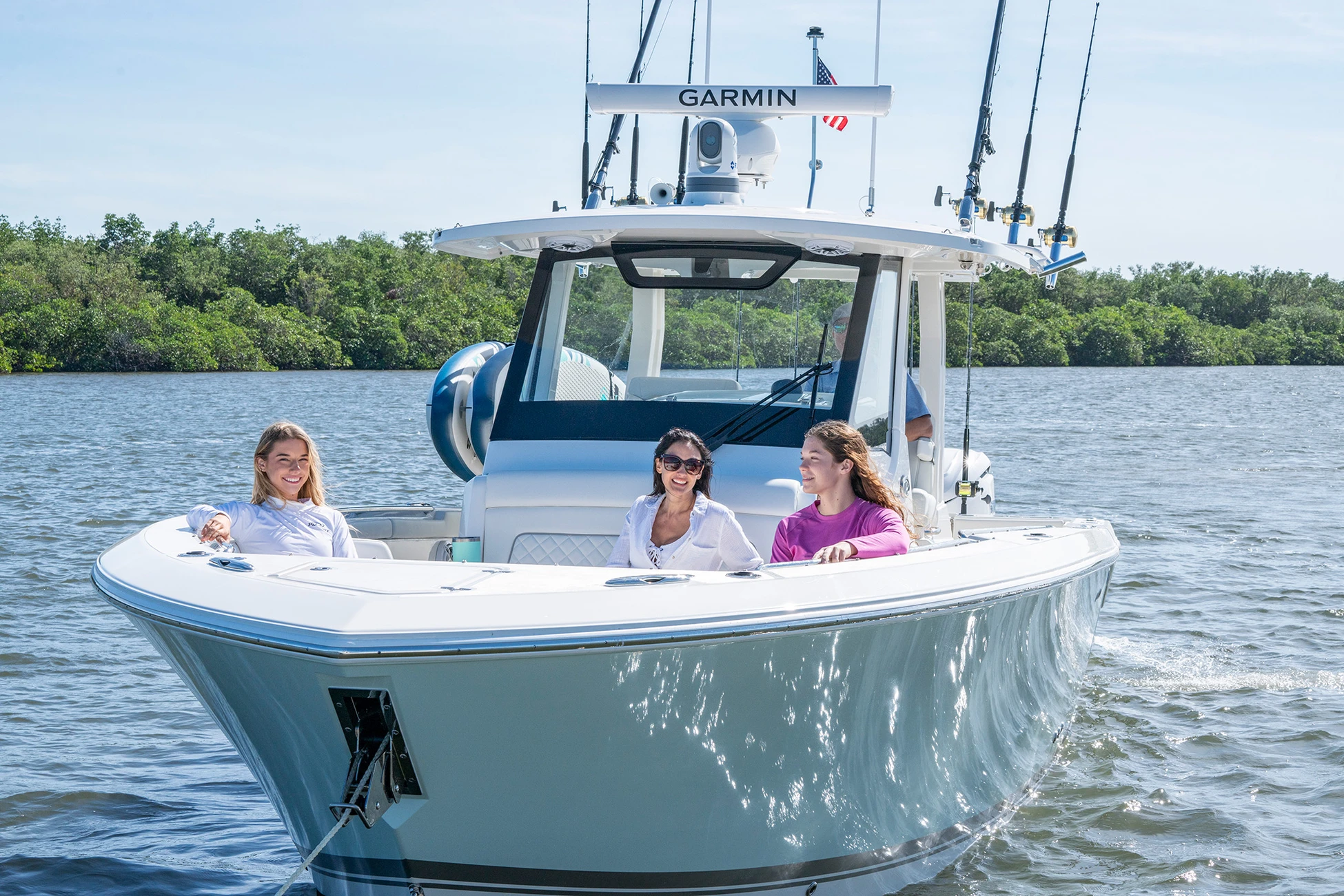 Ladies relax on the bow of a center console boat