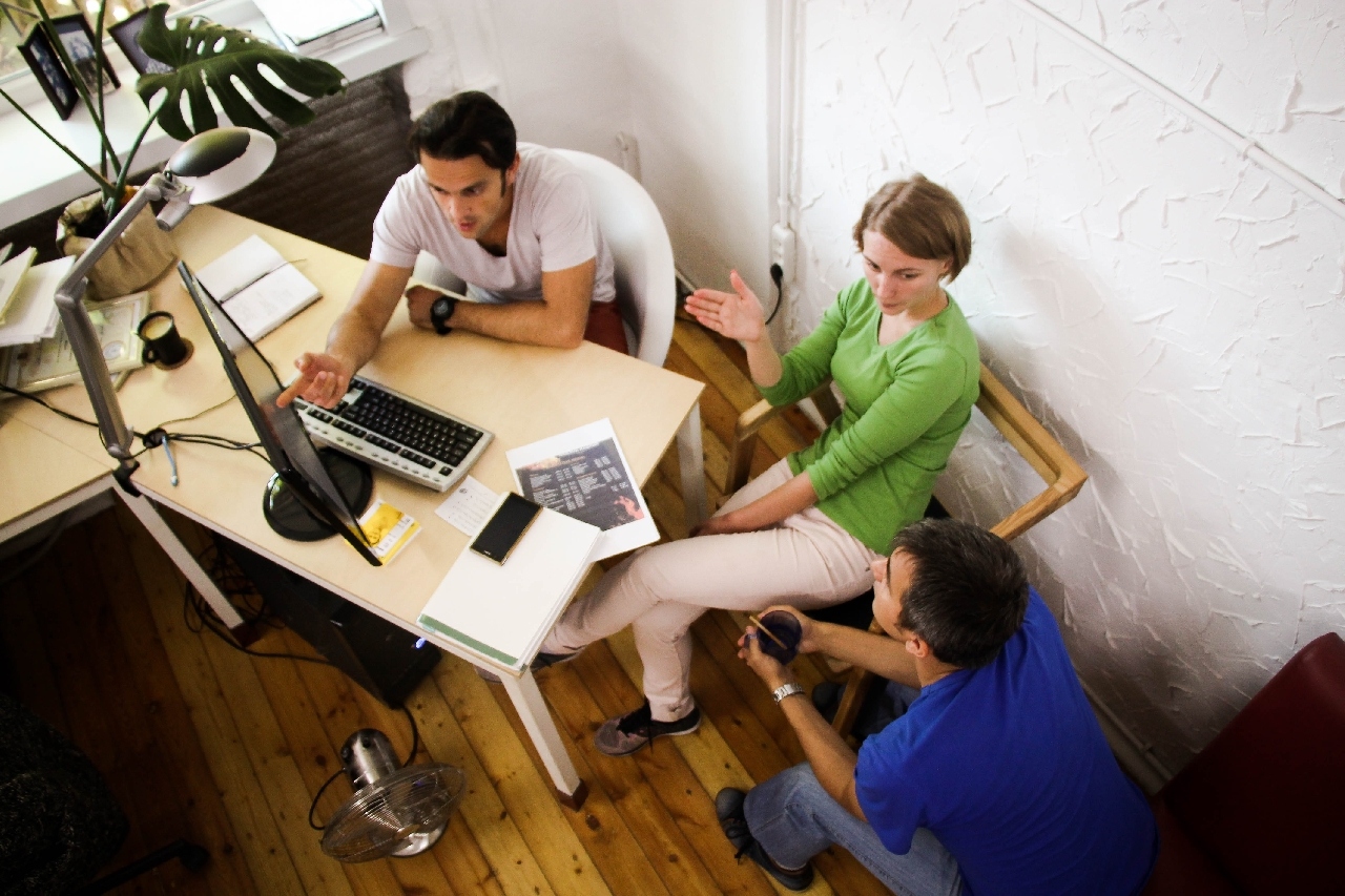 A startup team discussing how to free time by delegating time consuming, specific tasks.