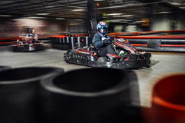 A person racing a go-kart at Podium Karting & Events 