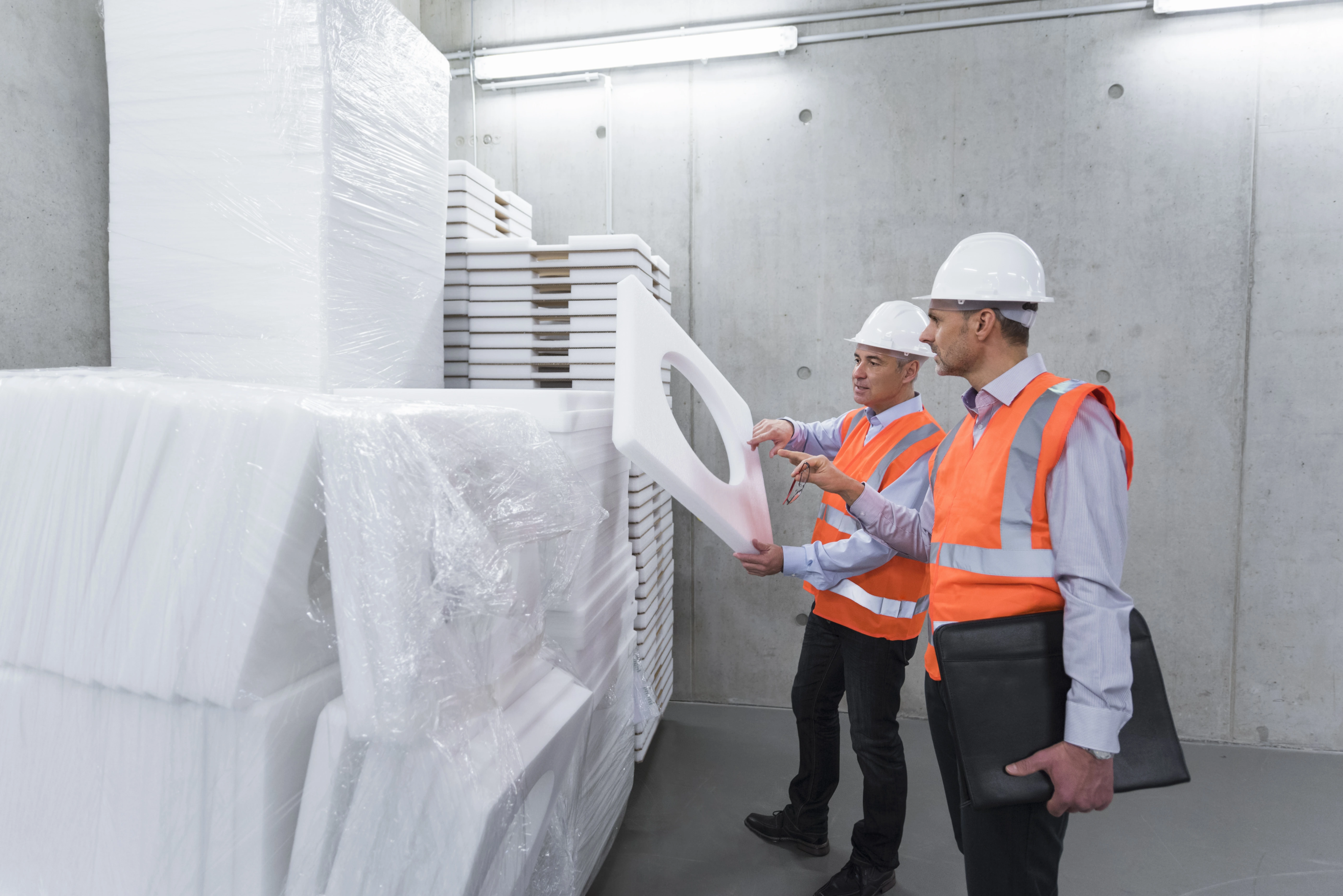 two colleagies examining expandable polystyrene insulation