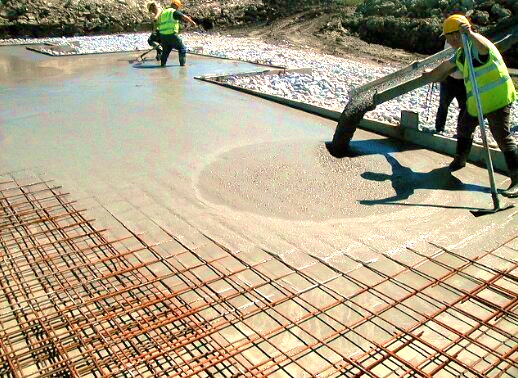 A picture of a construction site with workers using self consolidating concrete