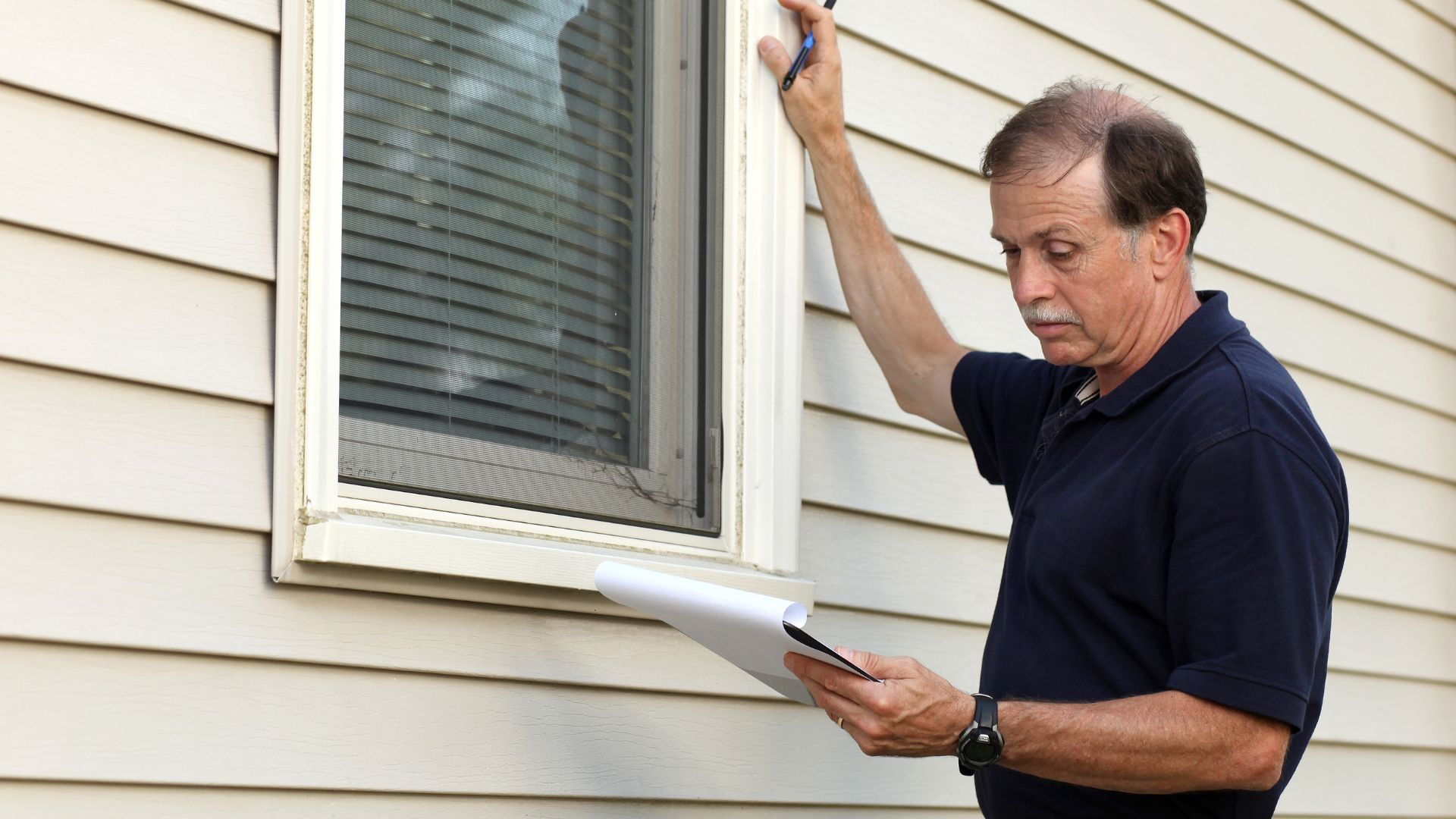 An image of a person inspecting potential pest entry points in his home.