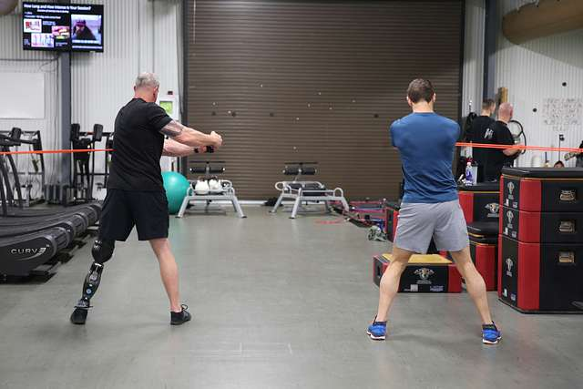 A person doing band external rotations to improve throwing arm