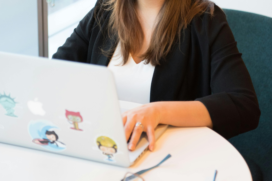 Filipino remote worker using a sticker-covered laptop, symbolizing remote work and LinkedIn job applications.