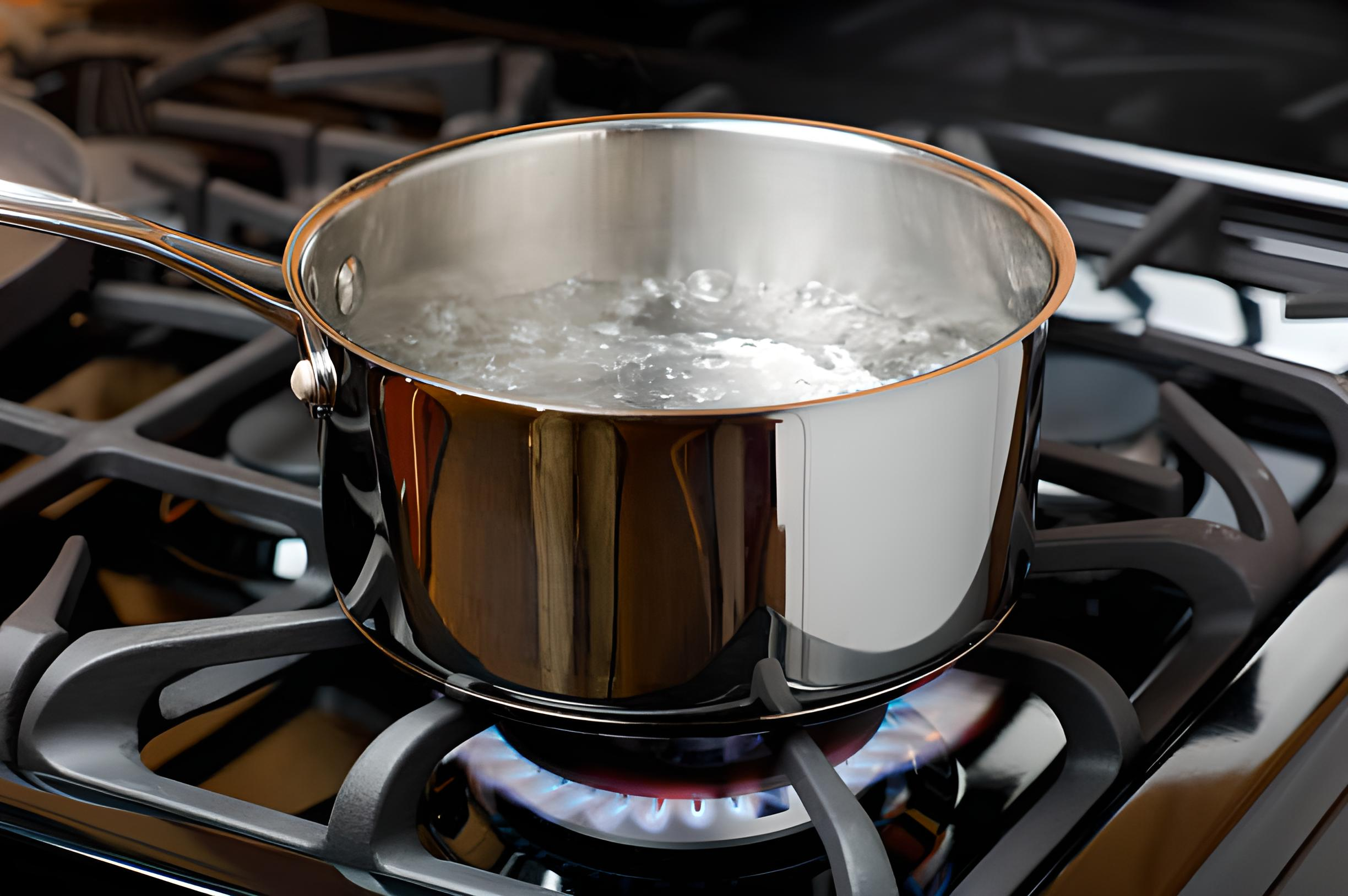 Boiling water in a pot, a step in DIY distillation for hard water and CPAP maintenance.