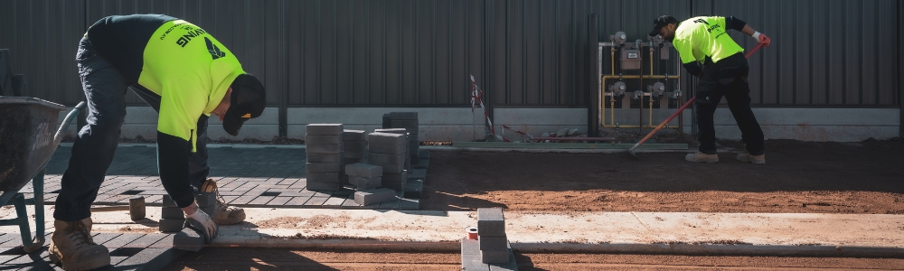 A group of experienced paving contractors working on a driveway paving project