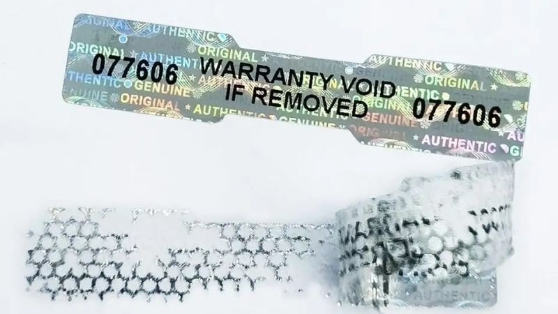 Holographic warranty label showing evidence of tampering