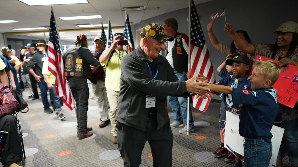 Veteran being greeted upon his return from a flight.