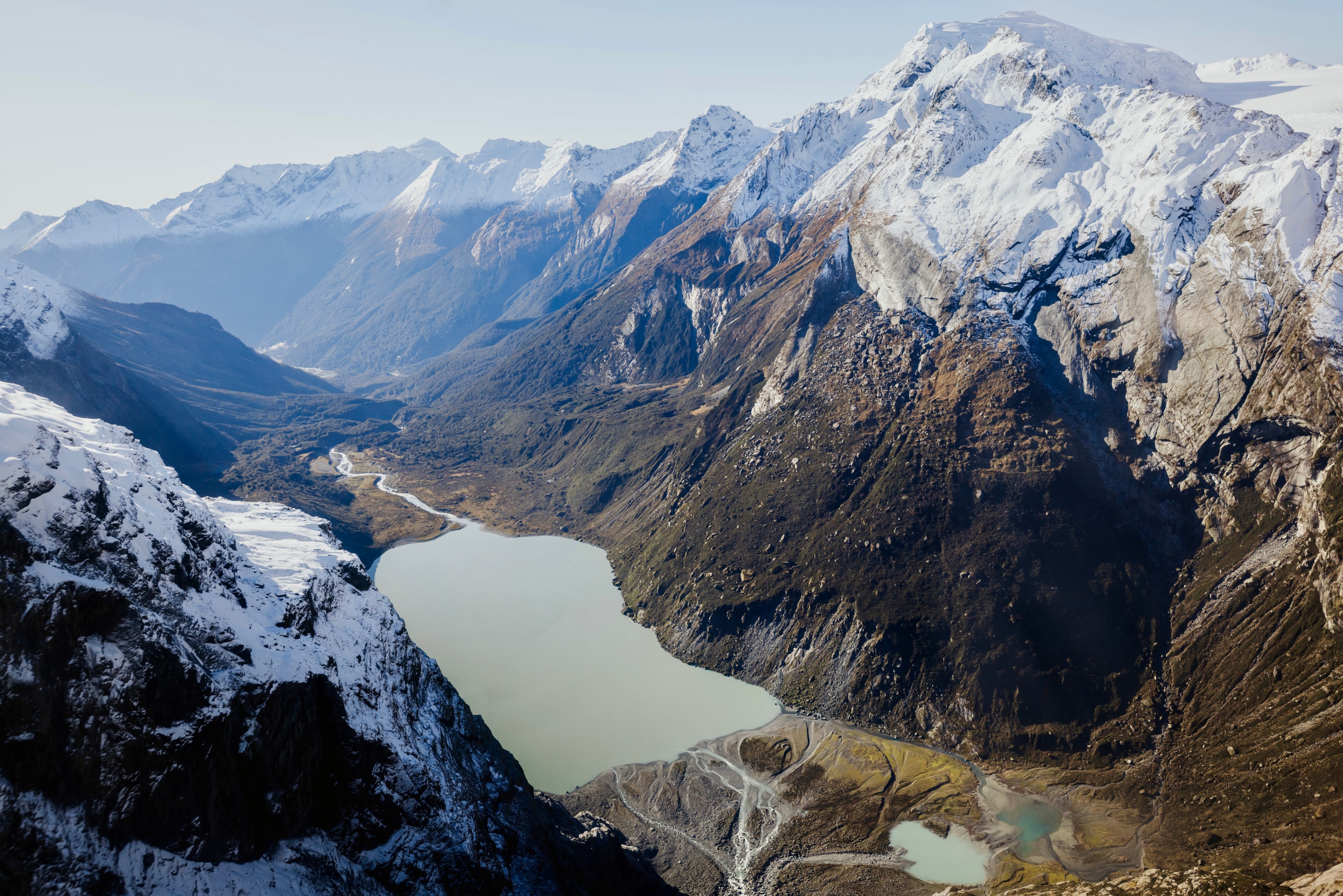 Helicopter flight over New Zealand's Fiordland National Park showcasing breathtaking views of mountains and glaciers.
