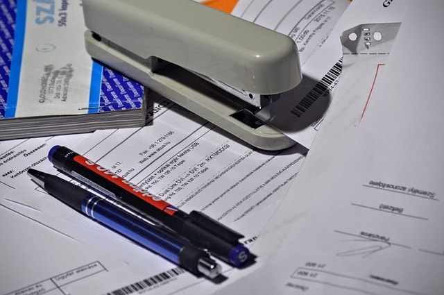 stapler, pen, paperwork