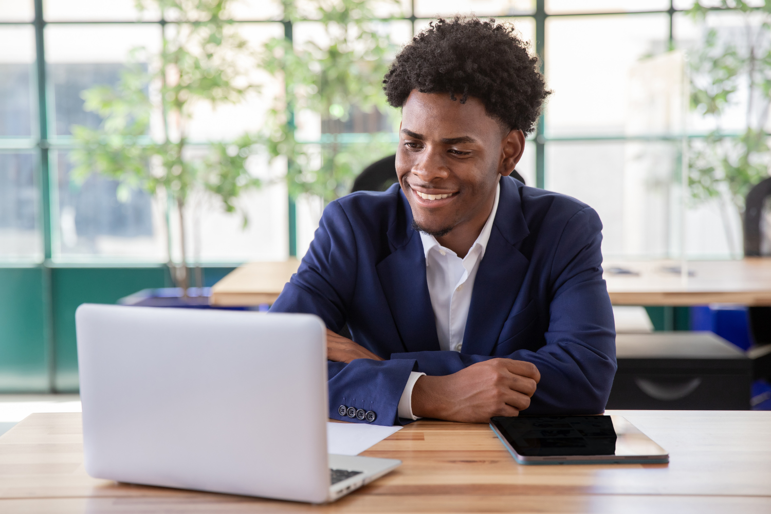 A smiling manager looking at his PC.
