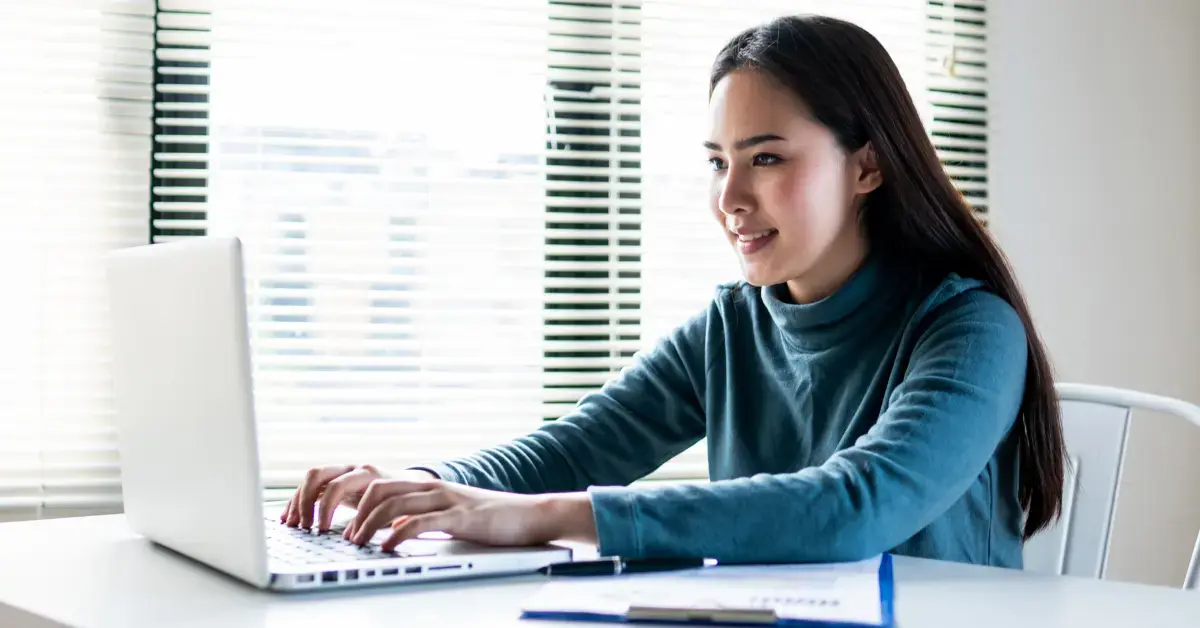 Woman reviewing LLC documents to amend articles of organization for business compliance.