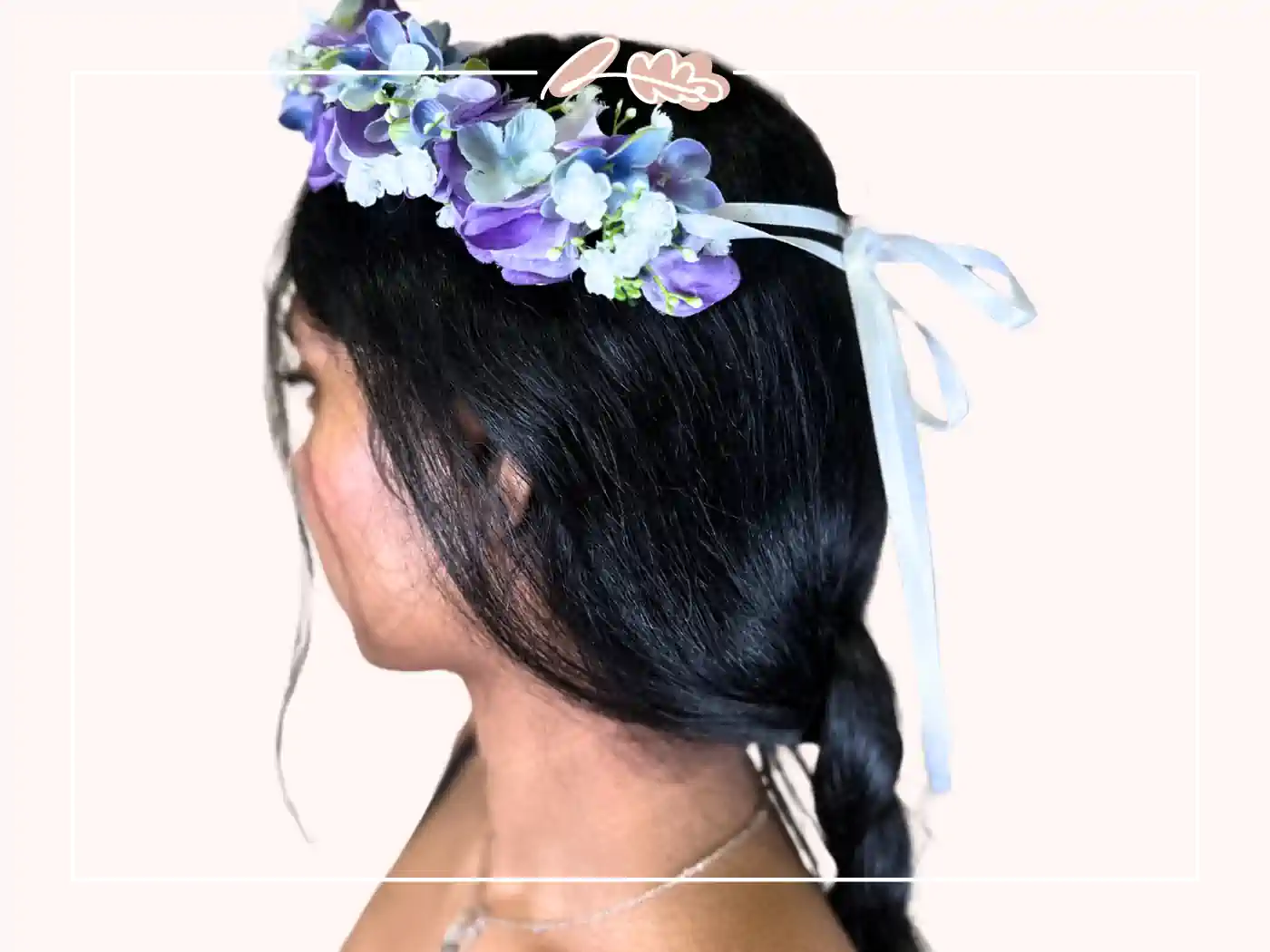 A woman with dark hair adorned with a lavender and blue floral headband. Lavender Dreams Floral Crown by Fabulous Flowers and Gifts.