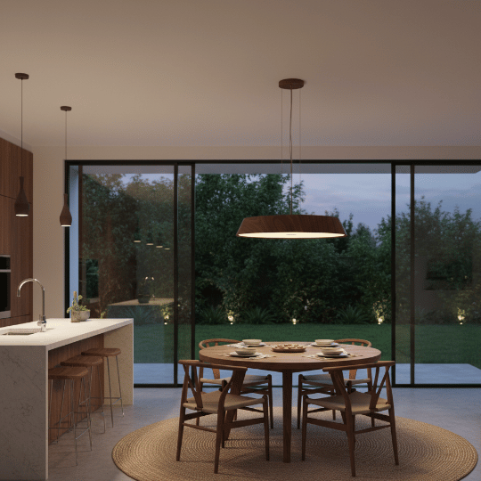 Wide wood pendant light centered above a round dining table.