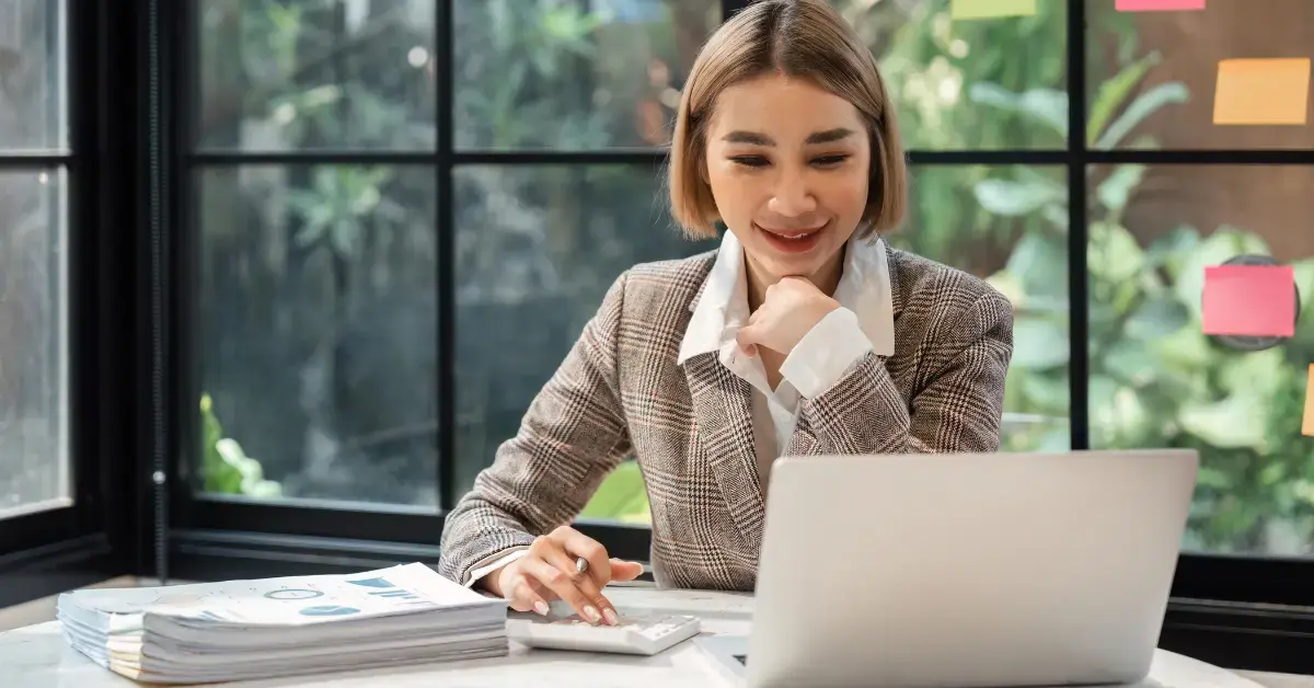 Woman organizing tax records and learning how to calculate monthly gross income accurately.