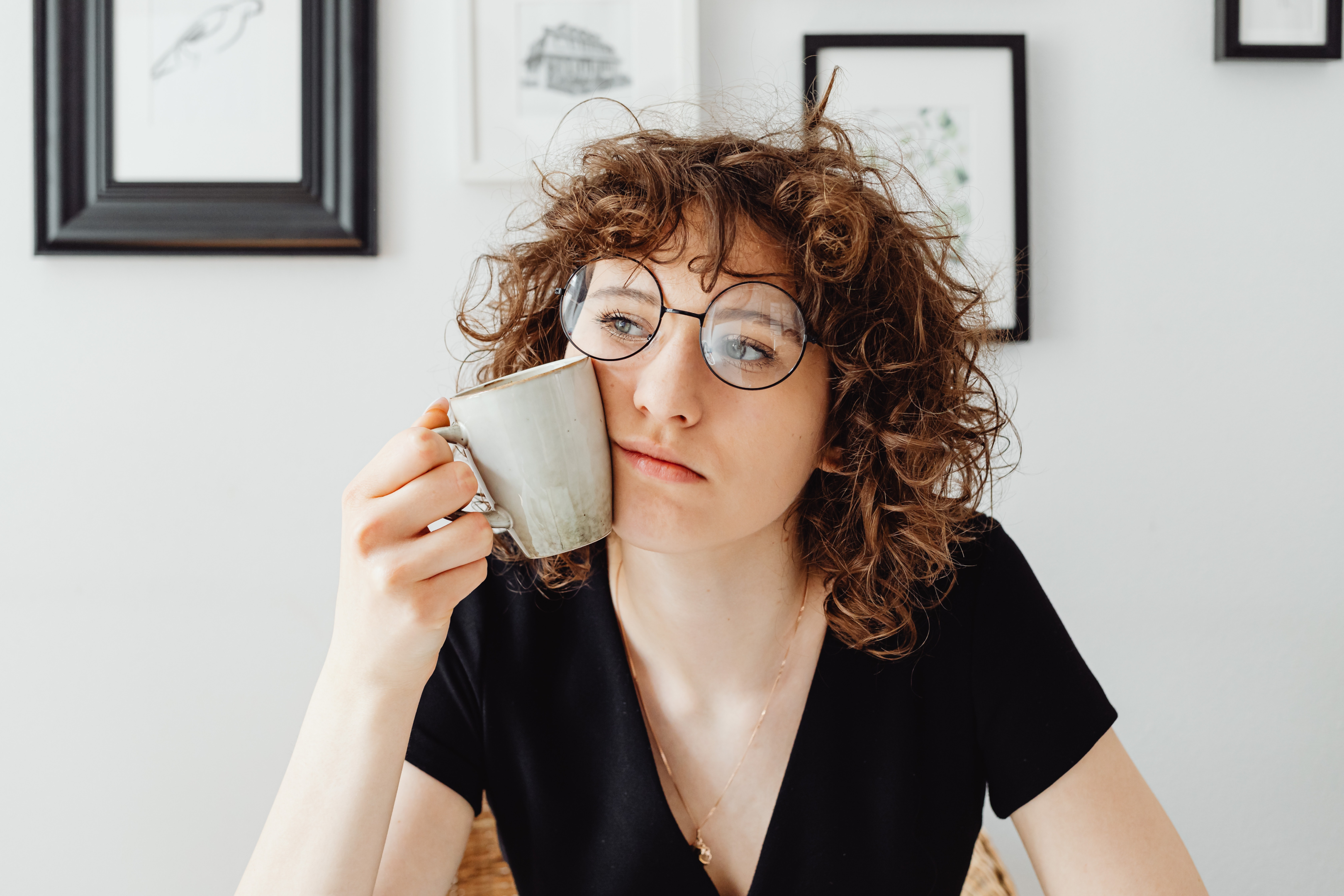 Woman thinking while holding a mug