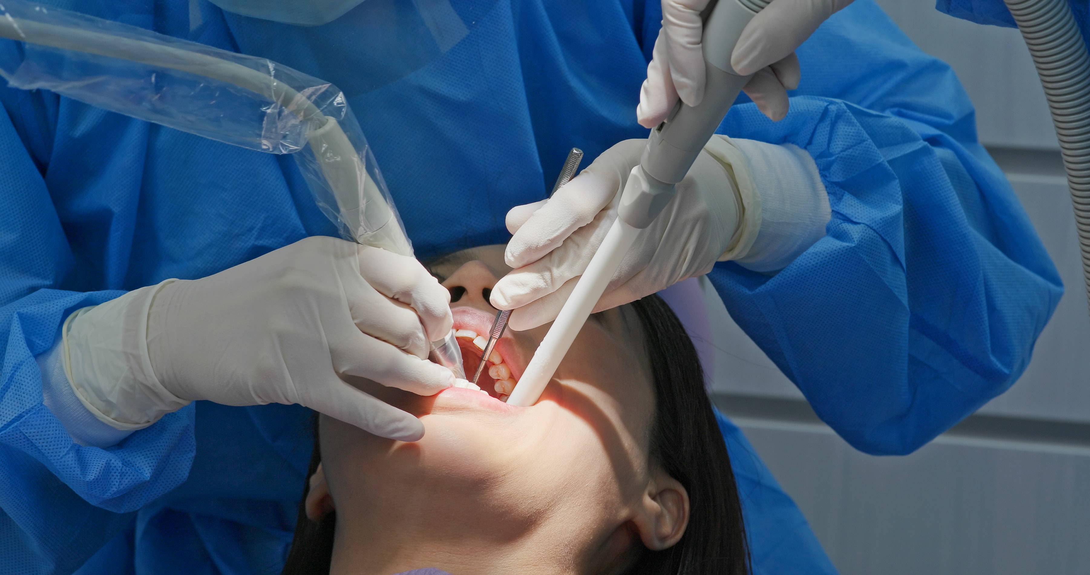 A photo of a woman after getting her tooth extracted.