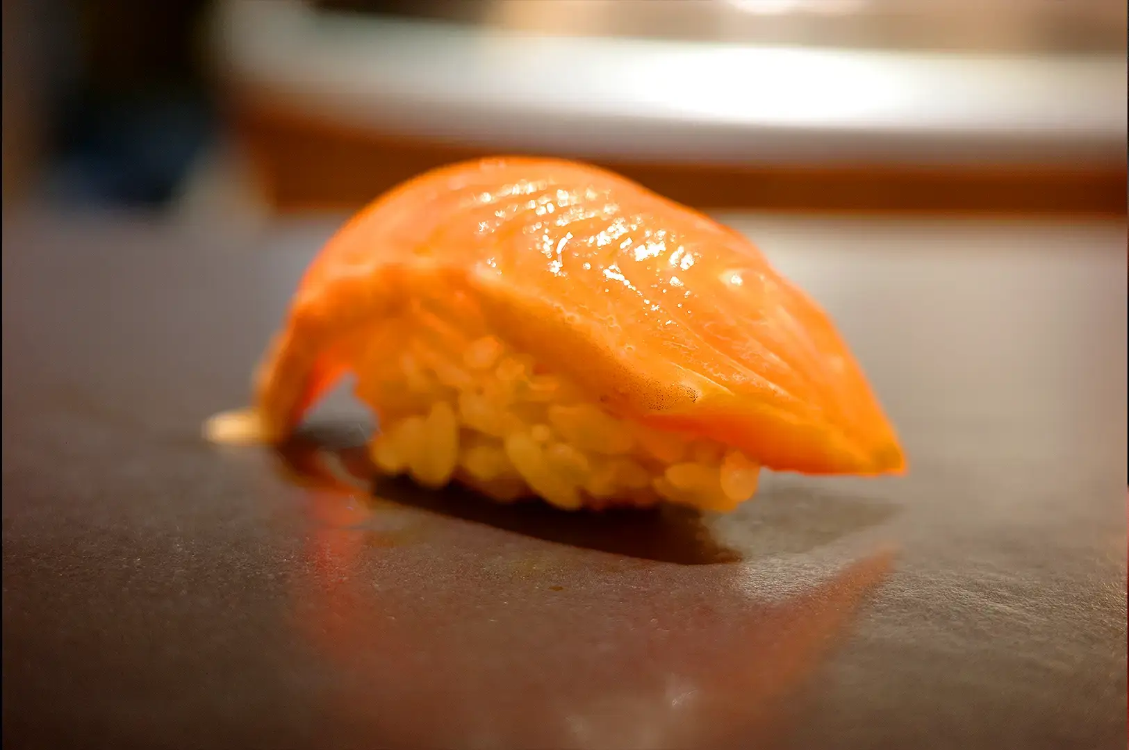Fresh salmon nigiri sushi served at a Singapore omakase restaurant with premium Japanese seafood