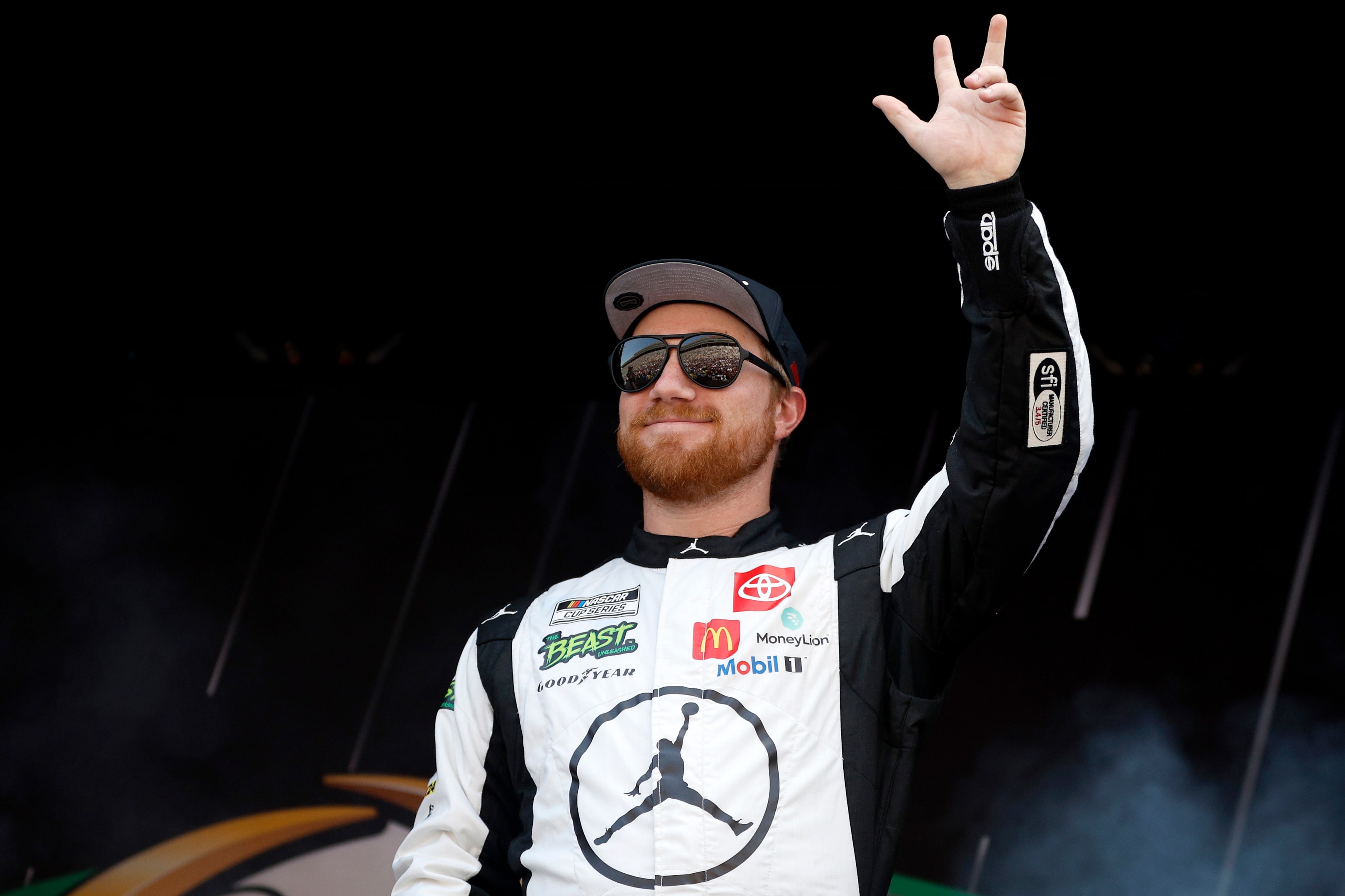 Tyler Reddick, driver of the #45 Jordan Brand Toyota, waves to fans as he walks onstage during driver intros prior to the NASCAR Cup Series Quaker State 400 Available at Walmart at Atlanta Motor Speedway on September 08, 2024 in Hampton, Georgia. 