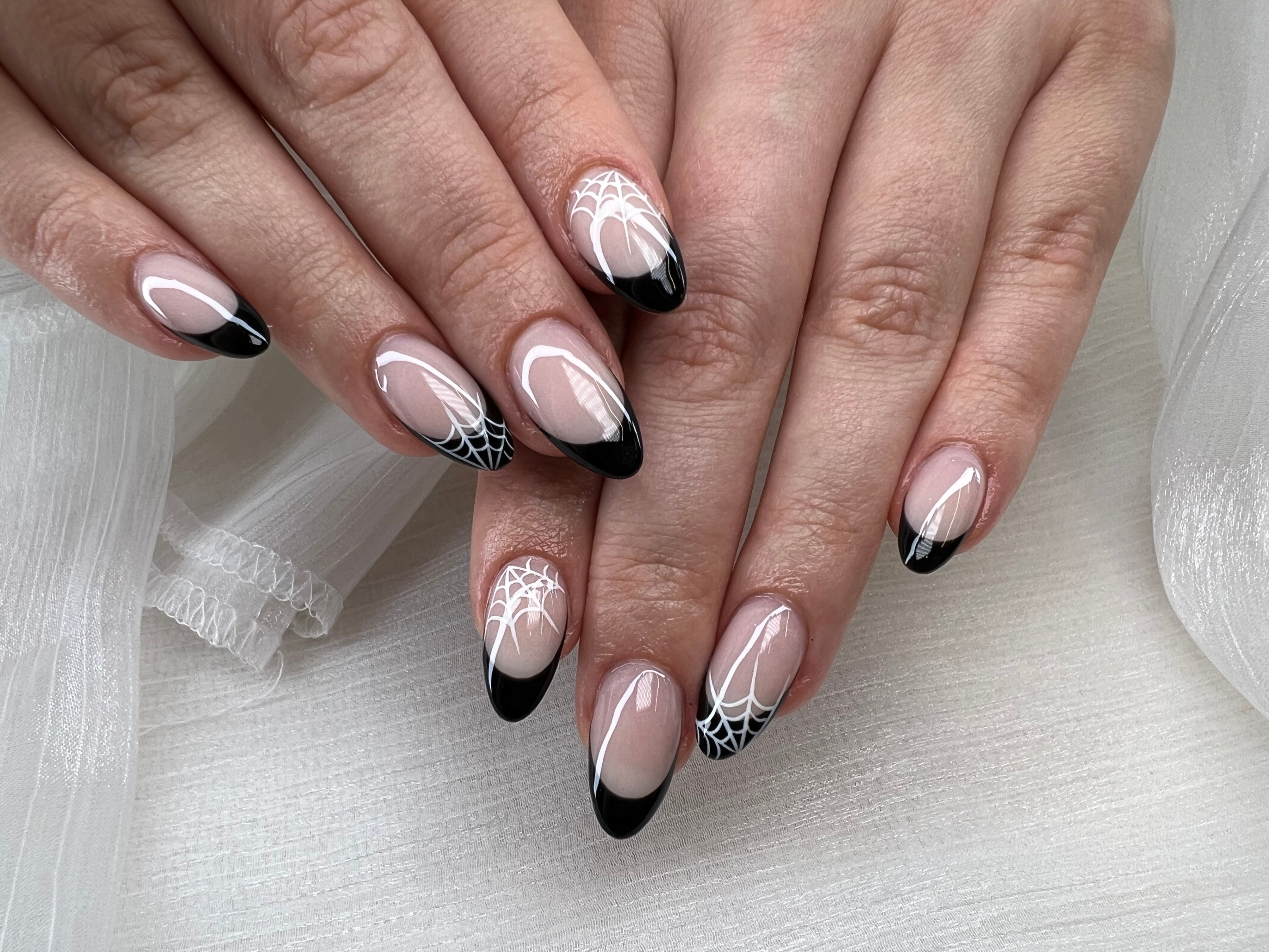 A black french tip manicure with classic shapes such as square and oval