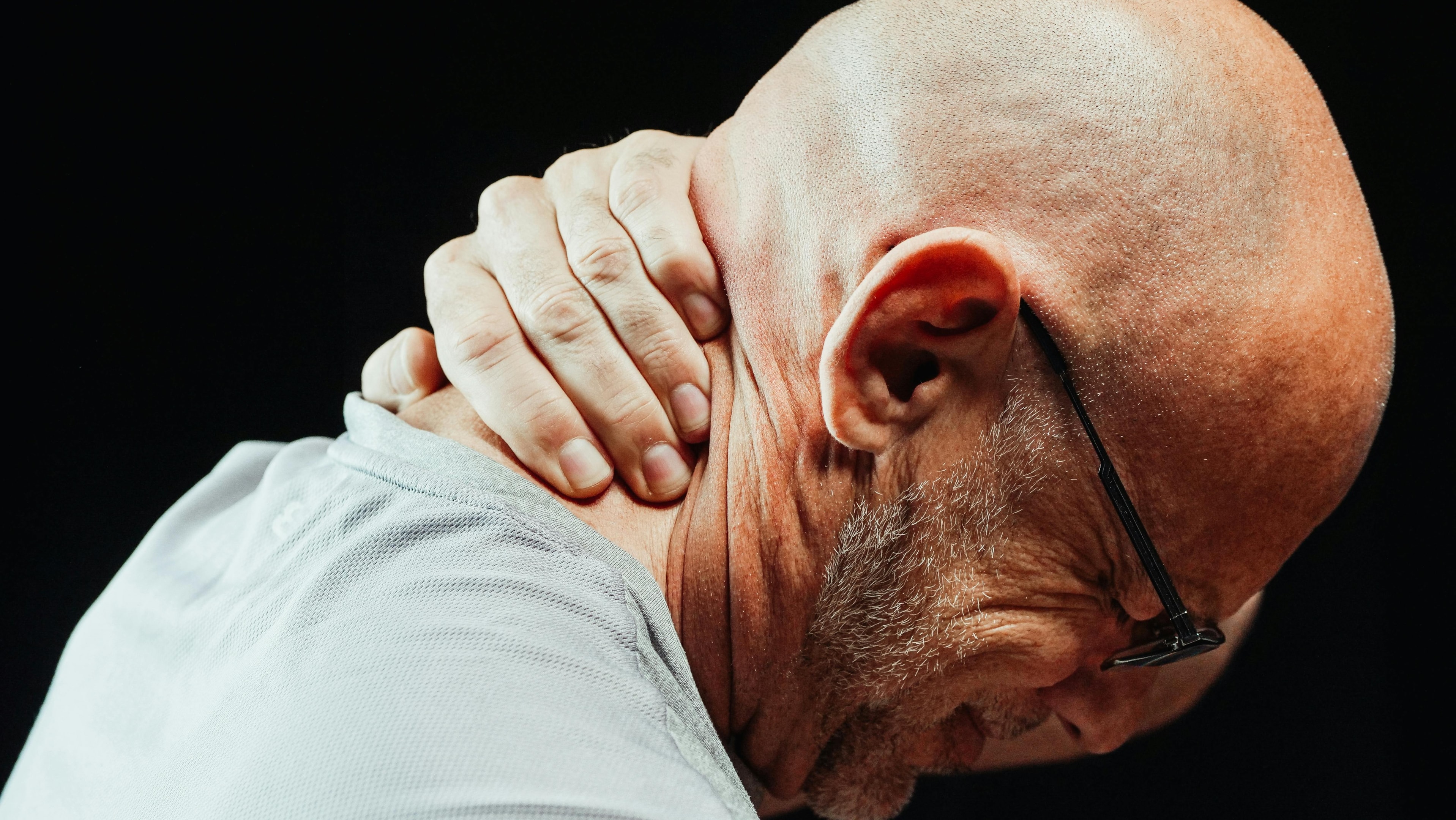 The image shows a person experiencing Neck Pain