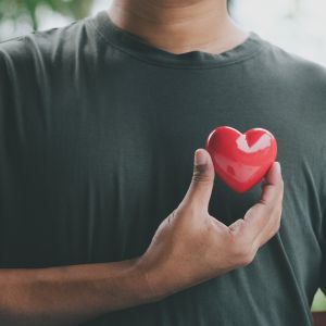 man holding heart symbolizing heart health