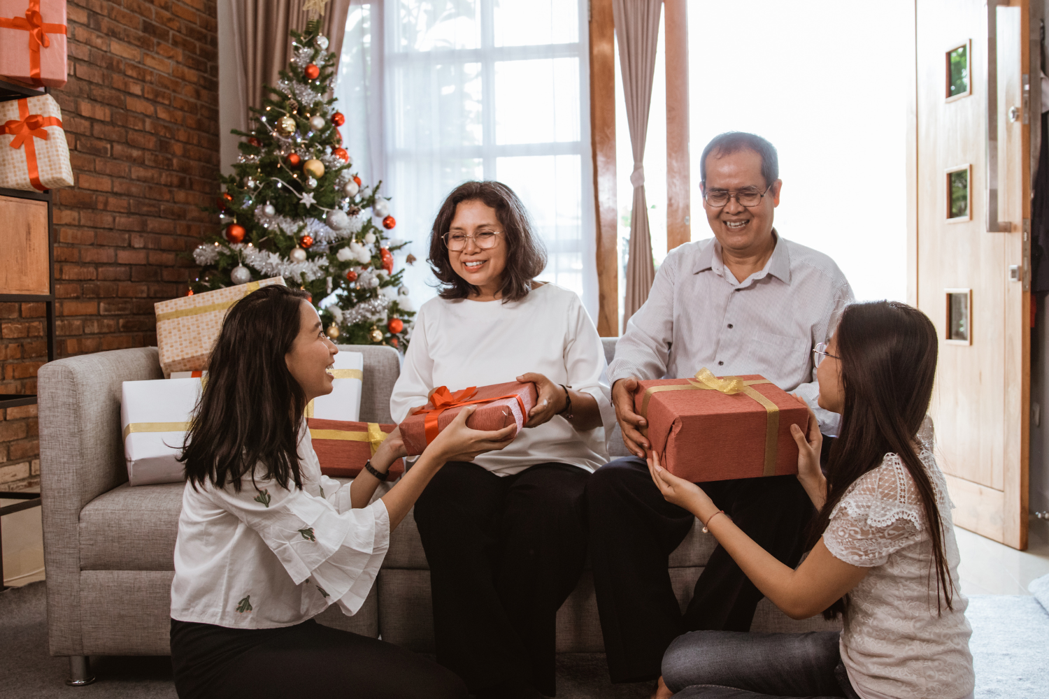 A Philippine family giving gifts to their elders on Christmas day.