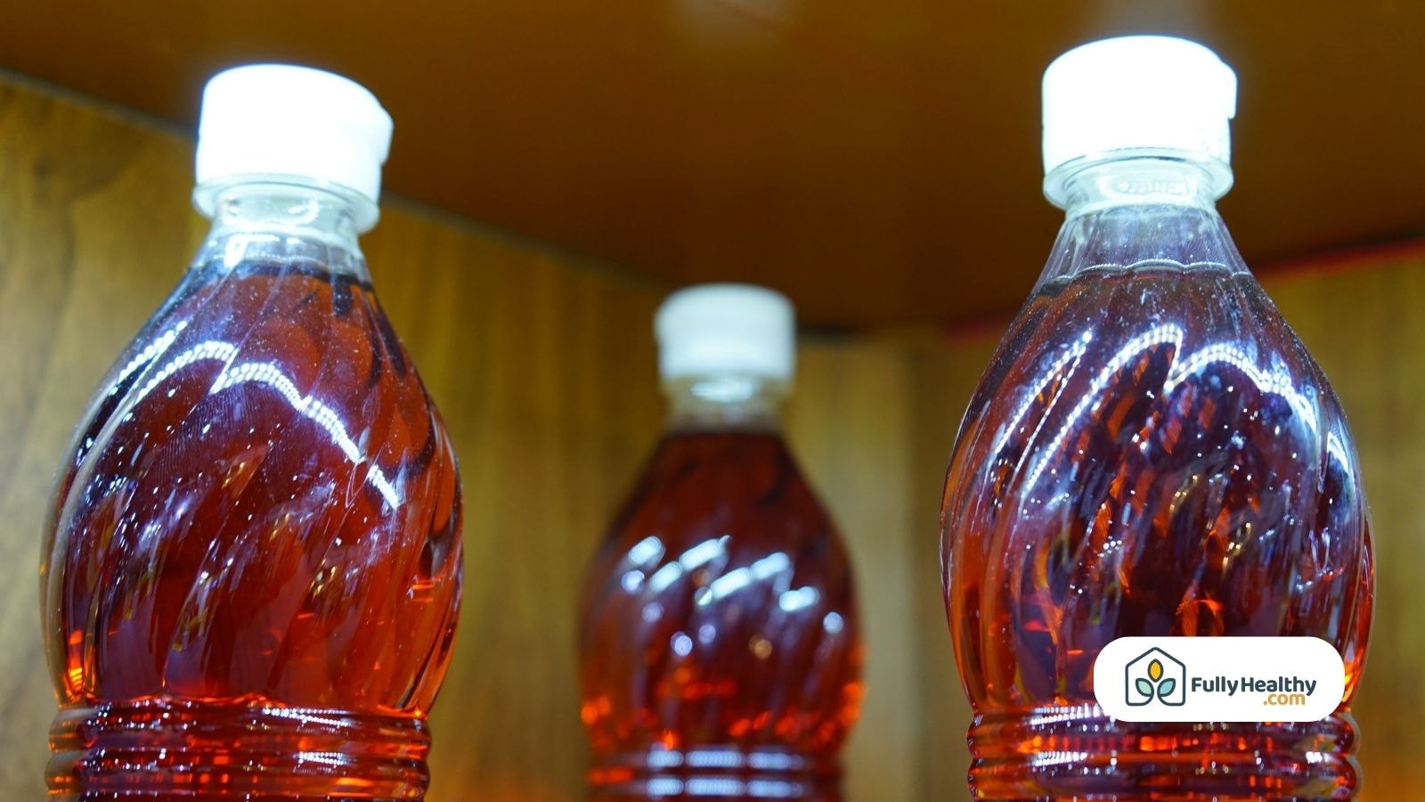 Bottles of red vinegar displayed on wooden shelf