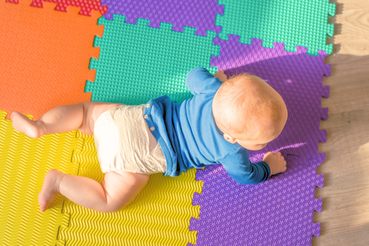 Baby doing tummy time on a foam mat