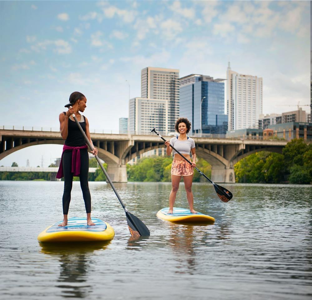 two women on stand up paddle boards