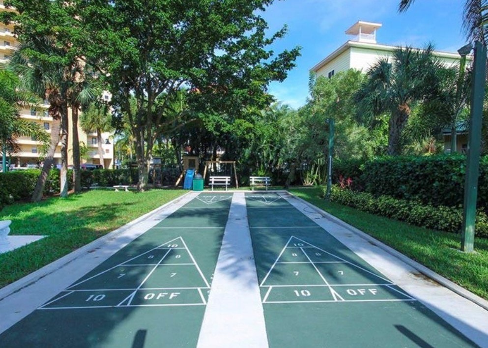 The image showcases a modern, updated kitchen in a Punta Rassa condo, featuring sleek granite countertops and stainless steel appliances, all complemented by stunning bay views. This inviting space is perfect for those interested in Fort Myers real estate, particularly in the desirable Punta Rassa area.