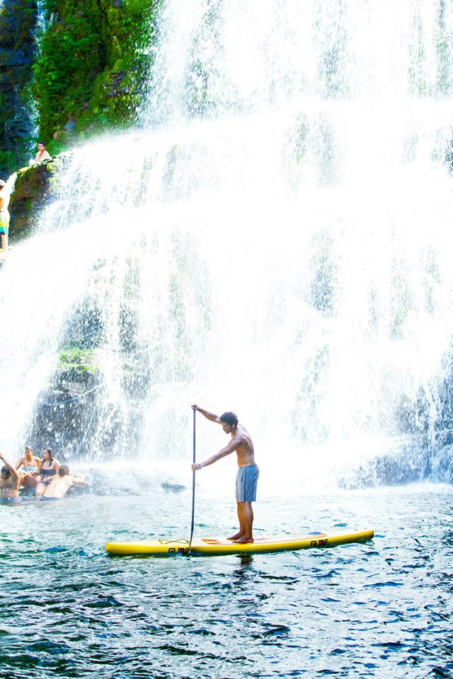 paddle board by a waterfall