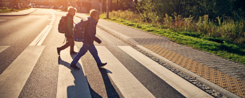 kids crossing street using pedestrian crossing