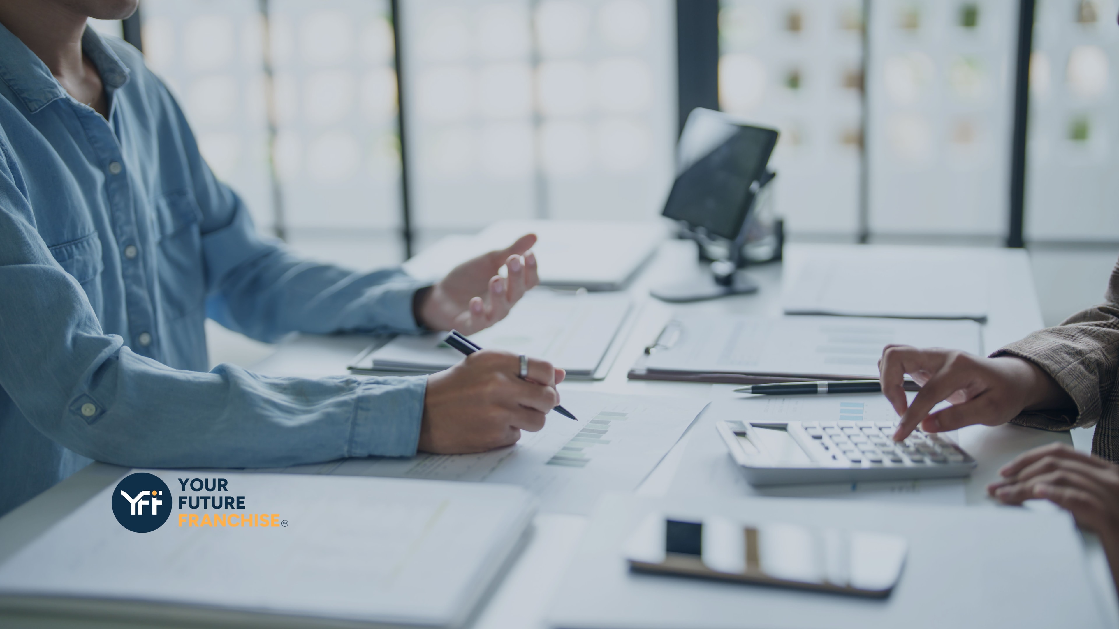Business people assessing costs with paper charts and calculators