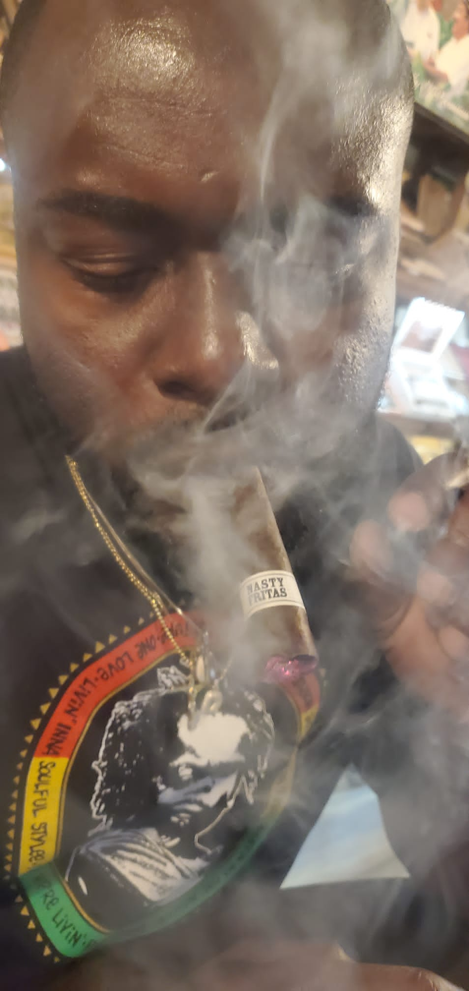 A man smoking a Liga Privada Unico Serie Nasty Fritas cigar