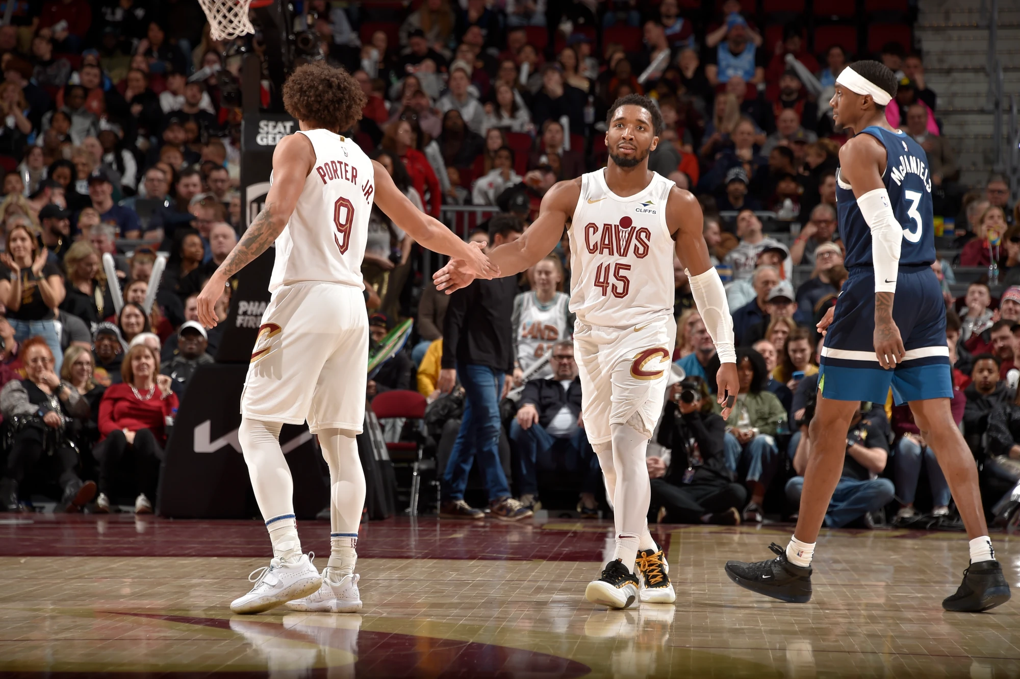 Craig Porter #9 and Donovan Mitchell #45 of the Cleveland Cavaliers high five during the game against the Minnesota Timberwolves on February 10, 2025 at Rocket Mortgage FieldHouse in Cleveland, Ohio.