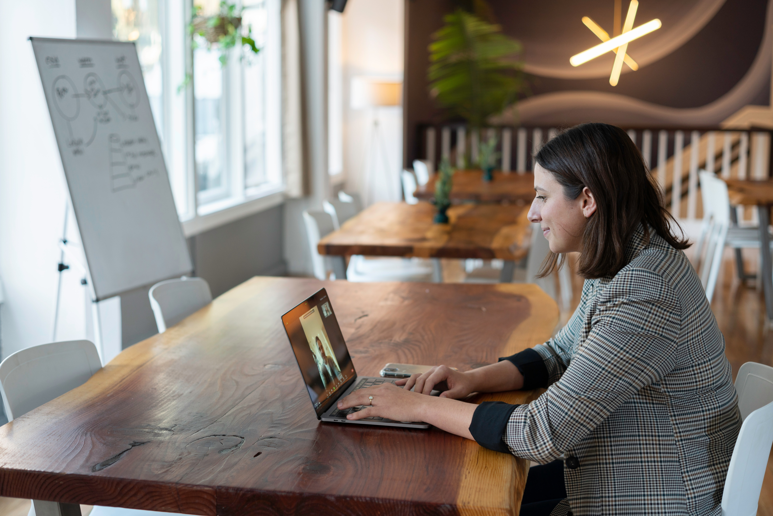 Photo of a salesperson working in an office on a virtual call. 5 Actions to Take When You Get a New Client | Brittany Corporation