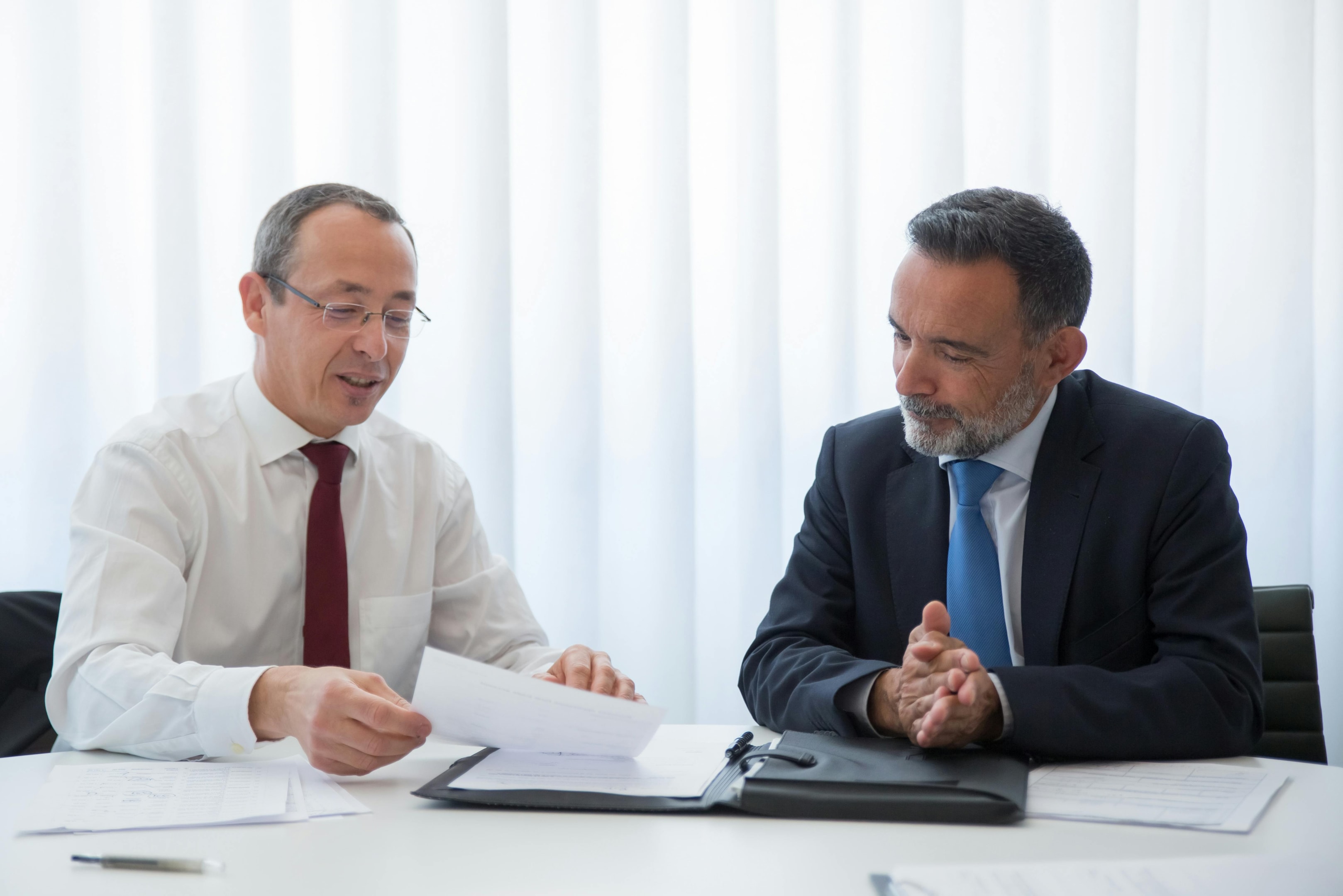 two men in office discussing contract