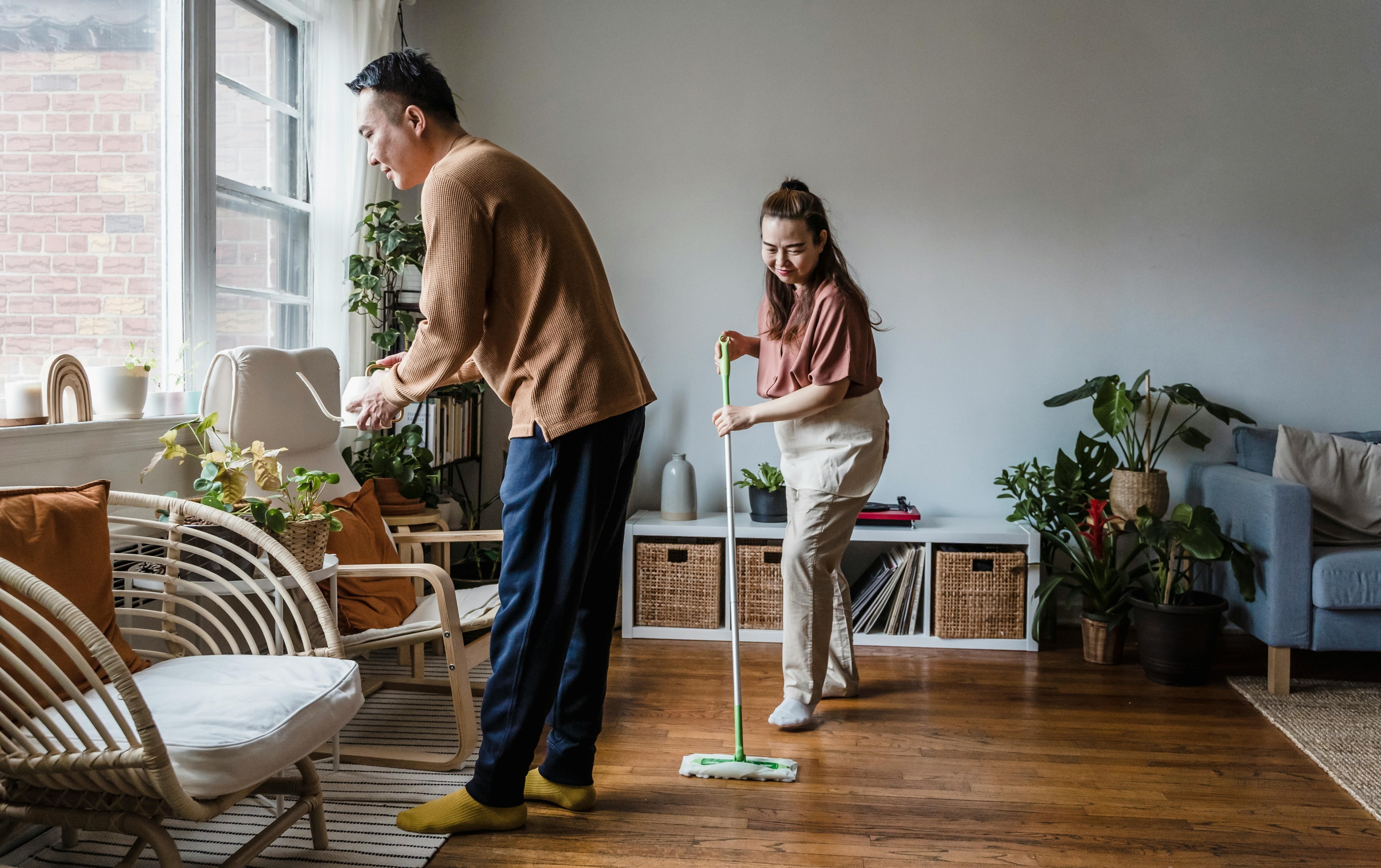 An illustration of a family vacuuming and dusting to keep their home dust-free.