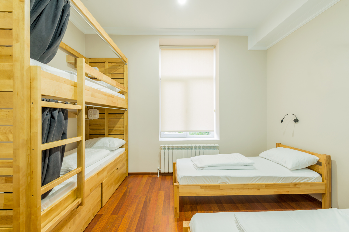 A cozy dorm bed setup with essential bedding items like pillows and blankets.