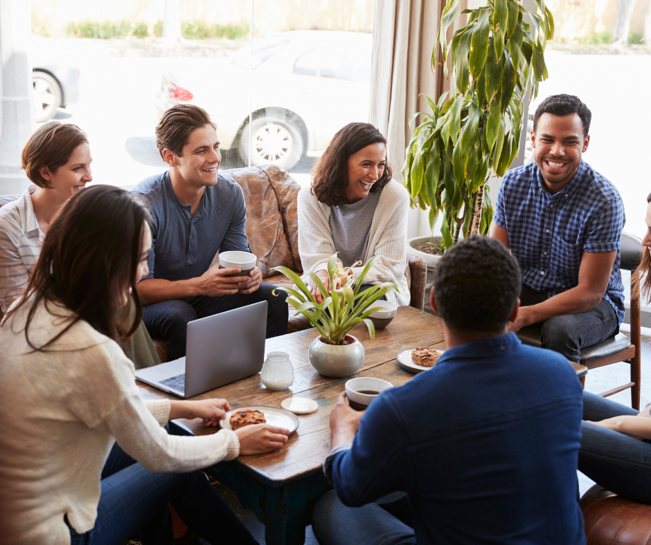                                           A group of friends and family members talking and laughing together