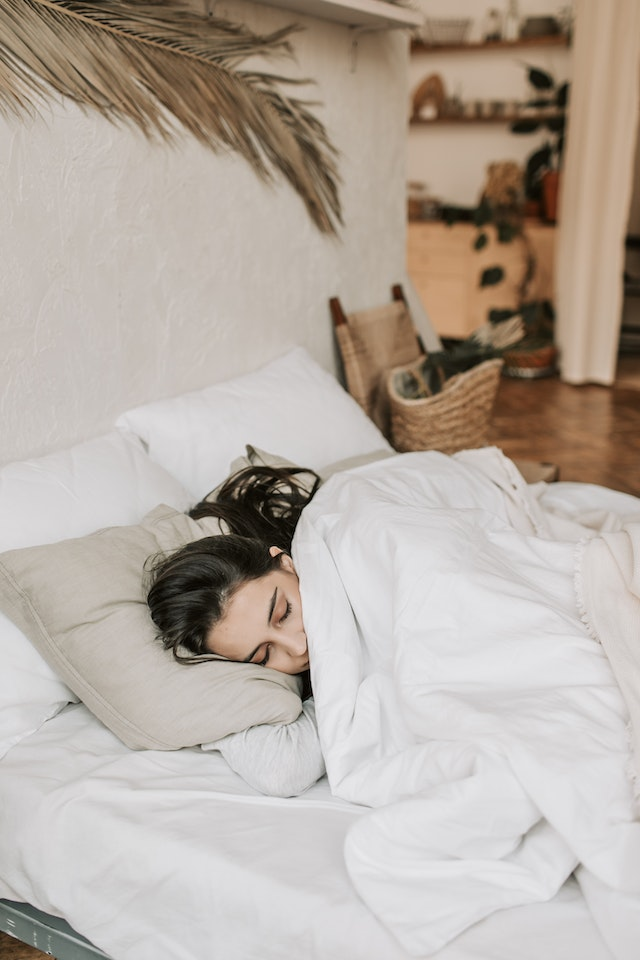 Woman getting quality sleep, helping promote healthy skin