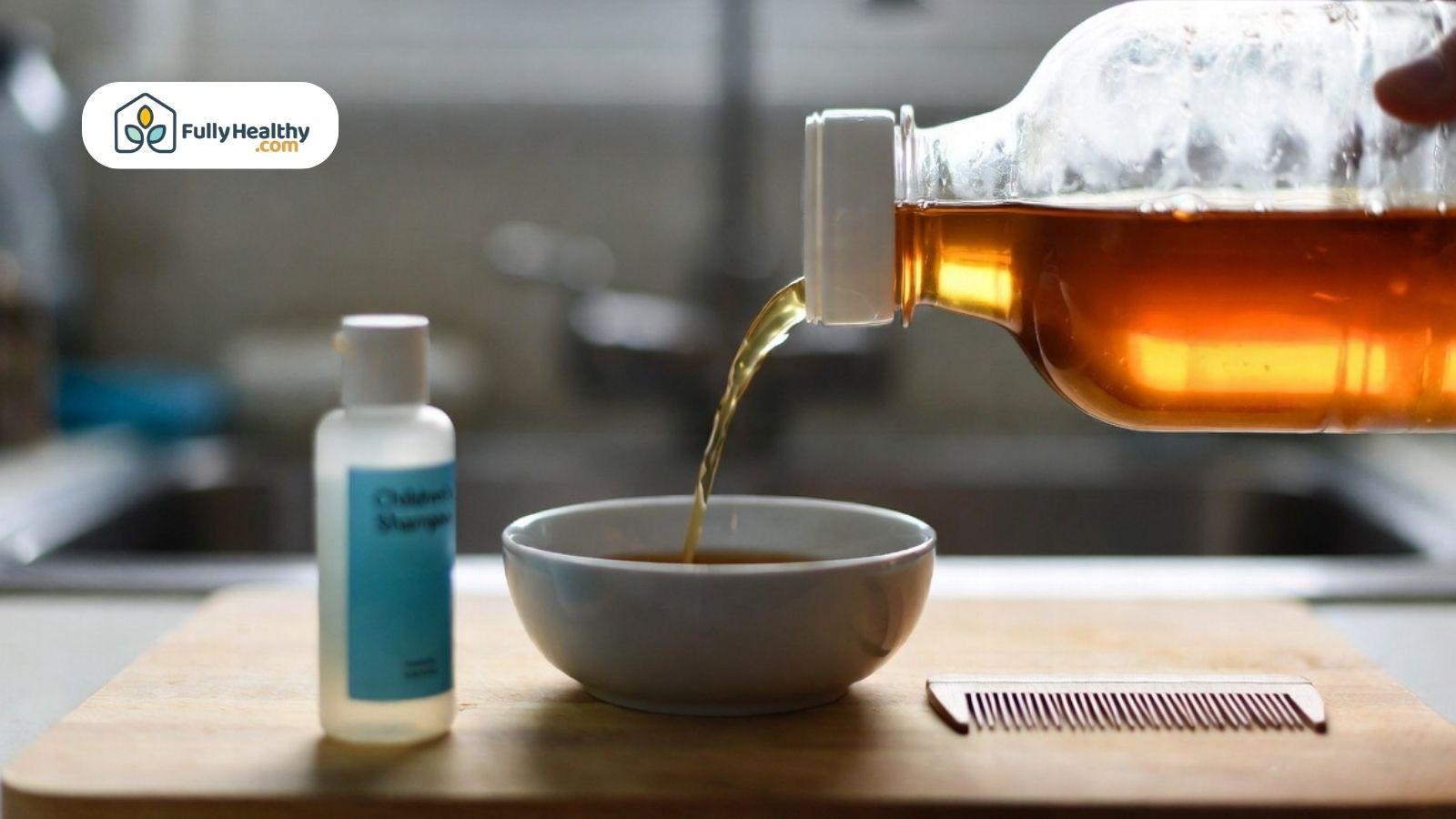 Apple cider vinegar with comb and shampoo used for head lice treatment.