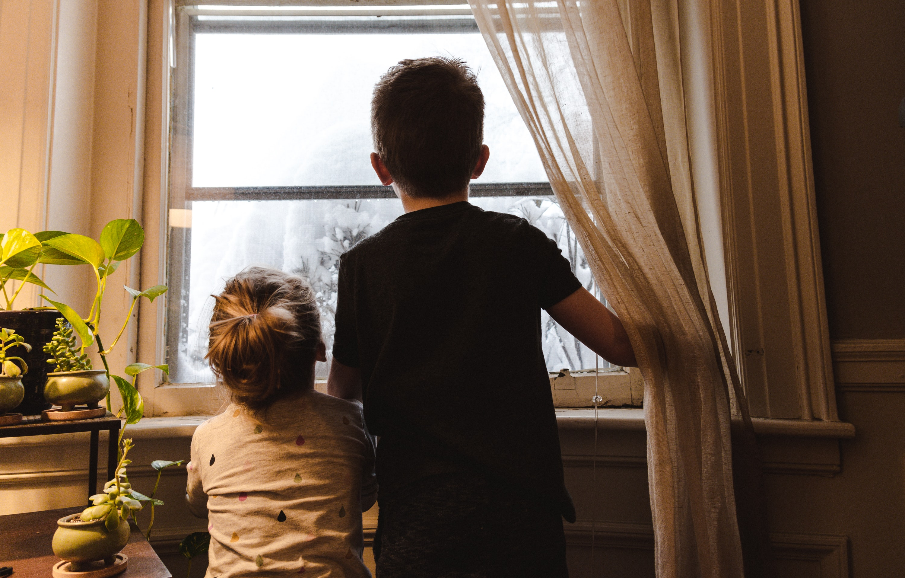 Image of two children looking at the window