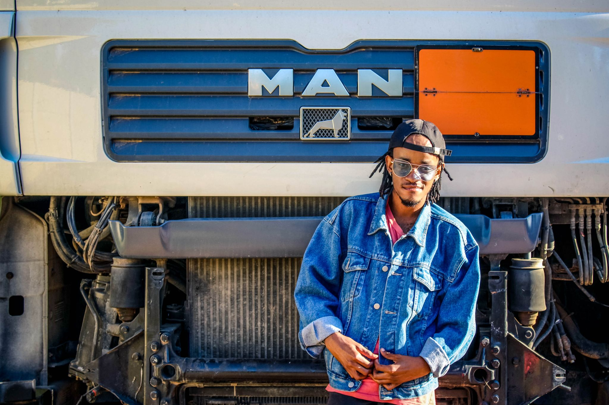 An open semi truck hood and person