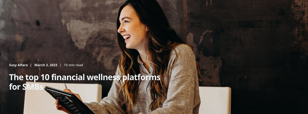 A young woman holds a tablet and smiles off camera. The title overlaid reads: The top 10 financial wellness platforms for SMBs