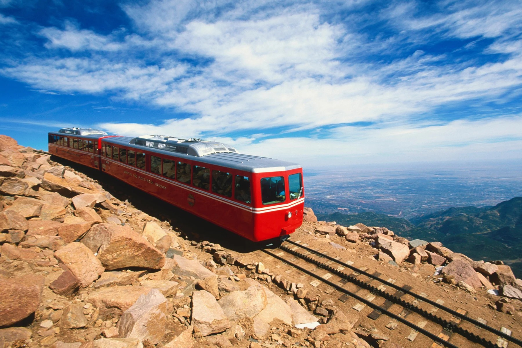 The Pikes Peak Cog Railway backdropped by mountain scenery 