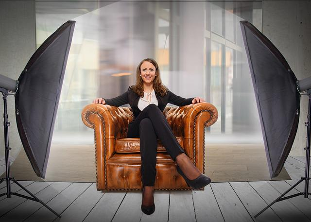 Business-woman-seated-in-big-leather-chair-building-her-personal-brand