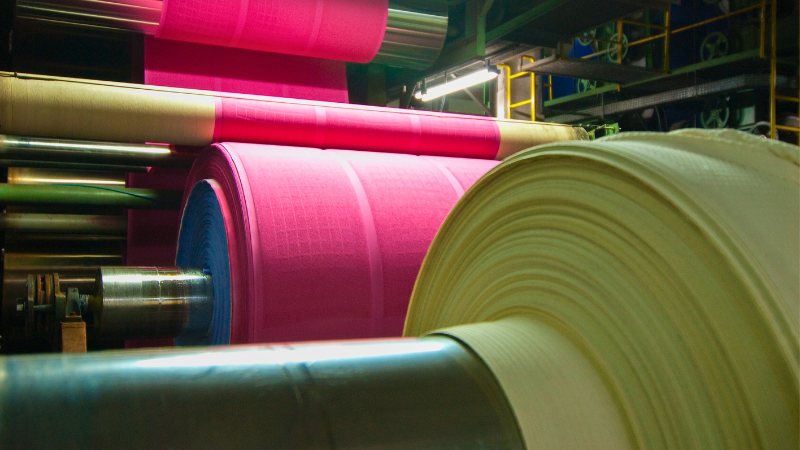 A close-up image of a yarn-dyeing industrial machine.