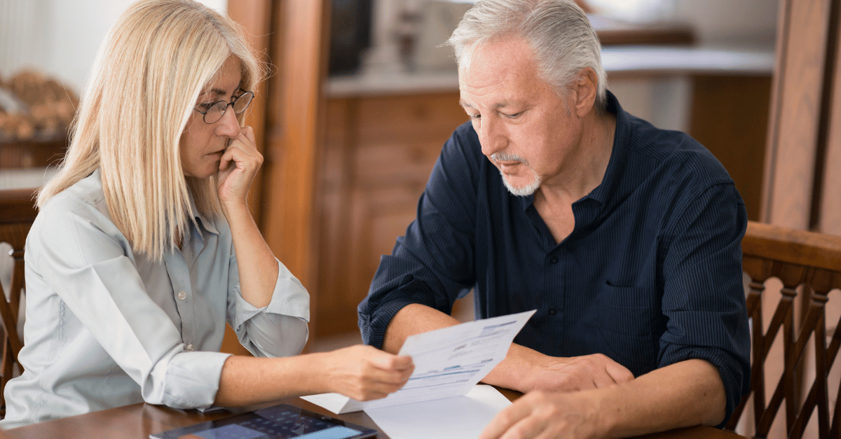 Illustration of a couple looking over retirement expenses. 